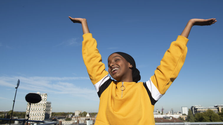 Kosar Ali in ROcks Girl raising her arms